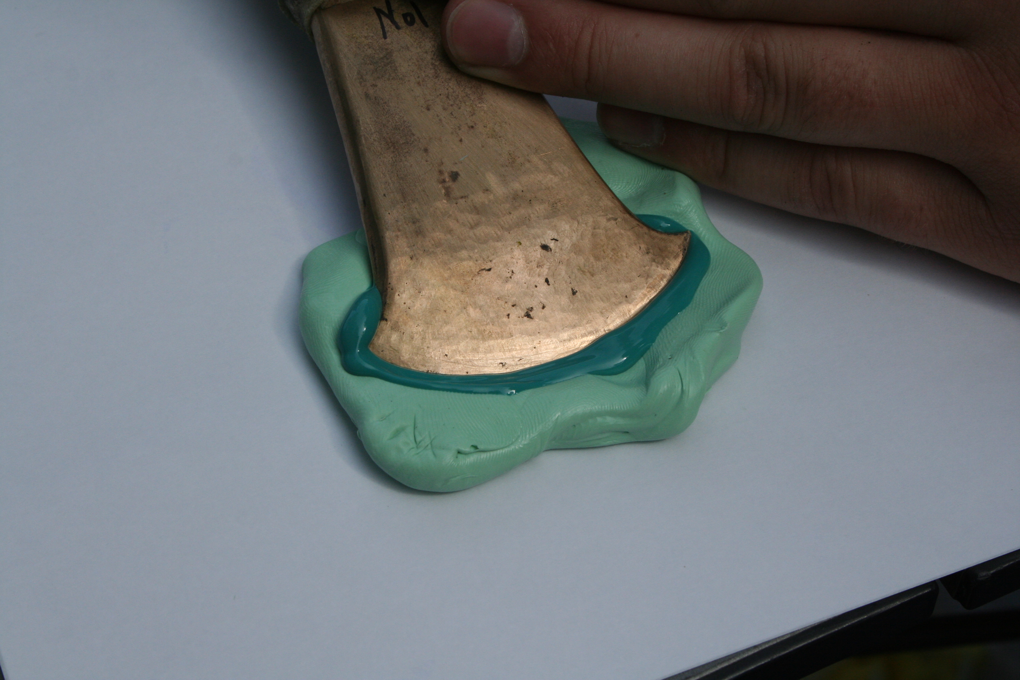 Taking a cast of the blade.  The putty is fine enough to show use wear marks.