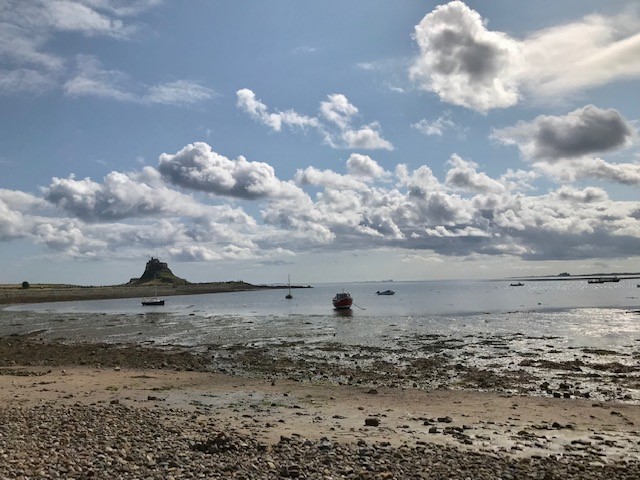 Lindisfarne Castle with boat in foreground