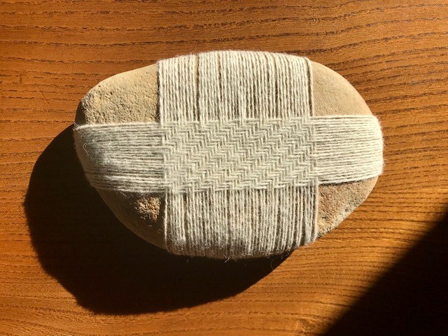 Stone wrapped in woven thread
