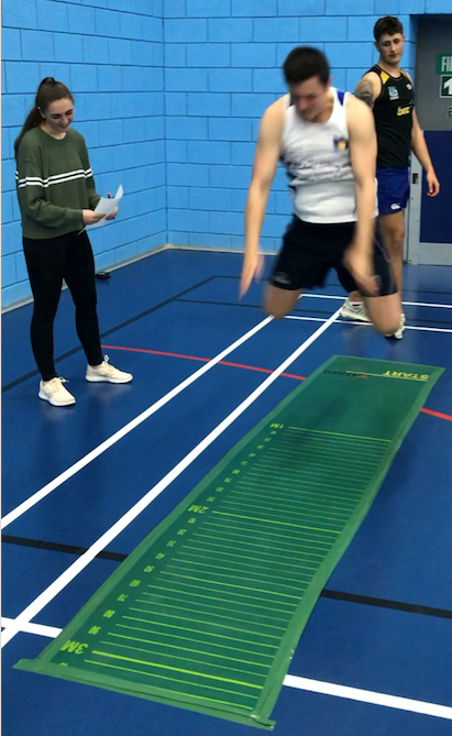 Anna ensuring a Performance Squad Player jumps as far as they can