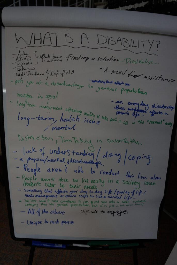 Answers to "what is a disability?" written on a flipchart. The text of the answers is below this image.