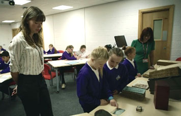 School children looking at archives and rare books