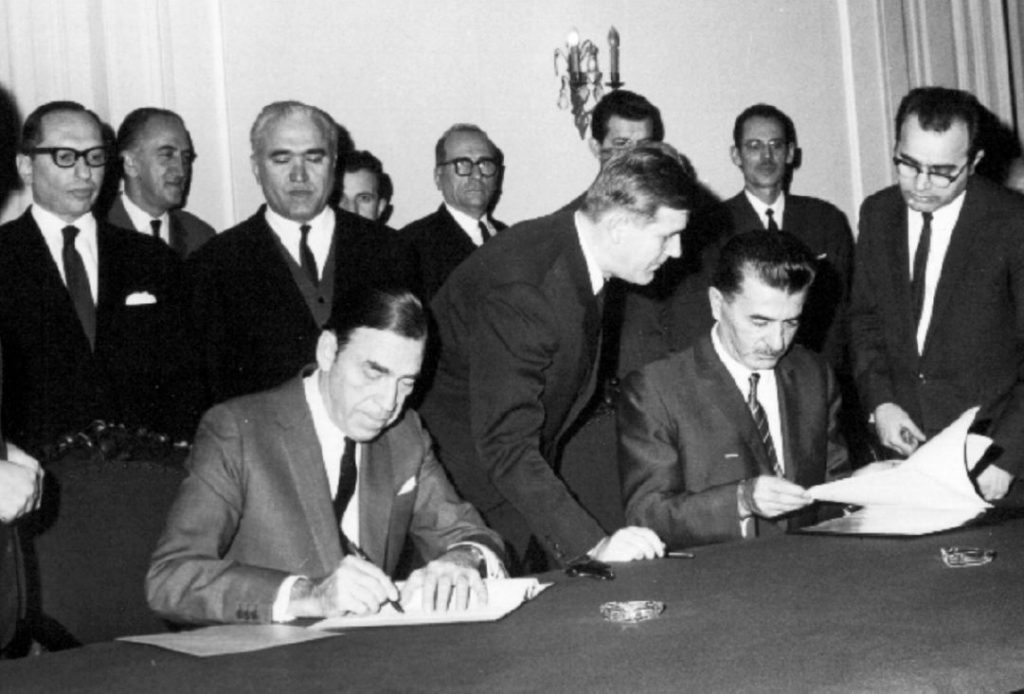 C. Burke Elbrick, U.S. ambassador (left), and Vukasin Micunovic, Yugoslav Federal Council President for Education and Culture (right), sign an agreement extending the U.S.-Yugoslav binational educational exchange program in December 1968. (Photo credit: The Fulbright Program, 1946-1996: 
