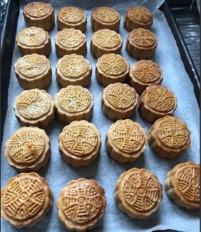 Tray of homemade mini moon cakes; small circular cakes,