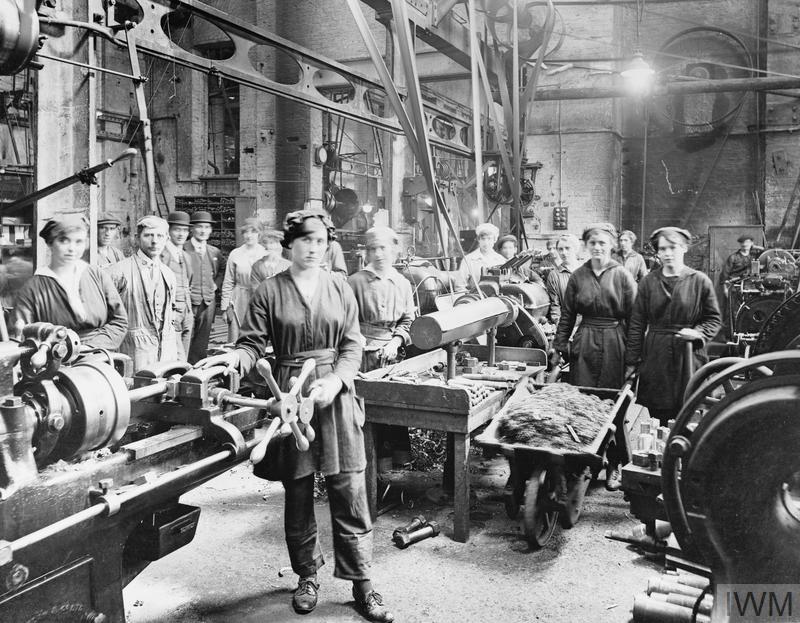 IWM, Q 110076, alt-text: women workers with male colleagues operating lathes and threading machines in a factory of Palmers Shipbuilding Company Limited at Hebburn-on-Tyne.