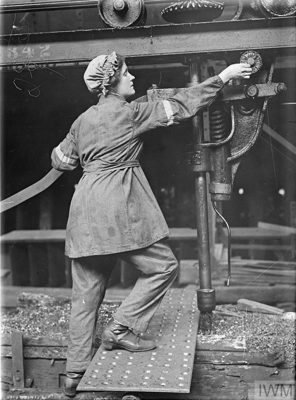 A woman worker adjusting a counter sinking machine at the shipbuilding yard of the Swan Hunter & Wigham Richardson, Wallsend (IWM, Q 20093)