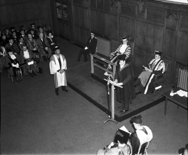 Photograph Depicts civil rights activist Dr Martin Luther King being introduced by Newcastle University's Public Orator J. H. Burnett as part of his ceremony to accept an honorary doctorate of Civil Law on 13th November 1967. 