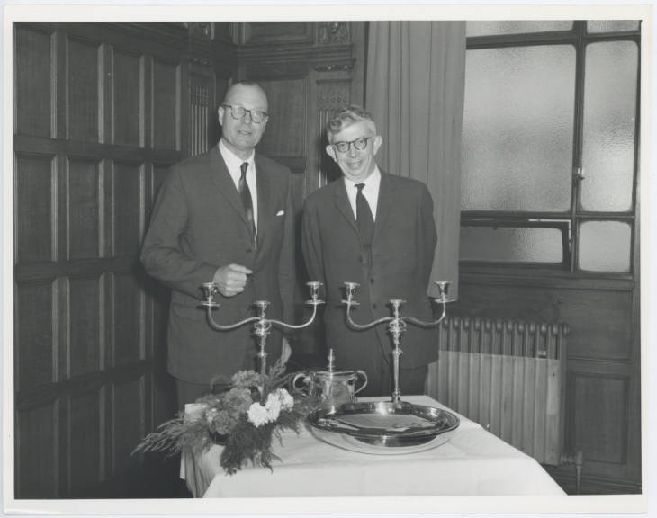 Photograph of Dr. C.I.C. Bosanquet, Vice-Chancellor of Newcastle University (left) and Dr. D.G. Christopherson, Vice-Chancellor of Durham University with the gifts exchanged between the Universities of Durham and Newcastle. 