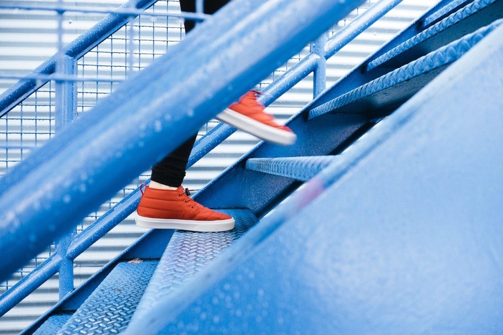 Someone walking up metal staircase