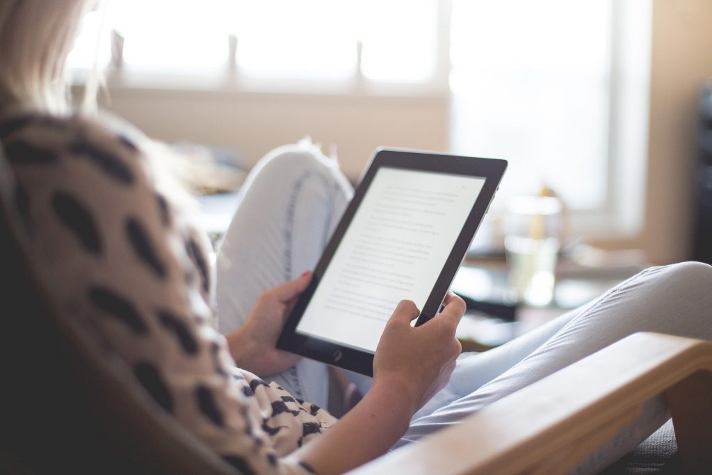 Woman reading on an eReader device.