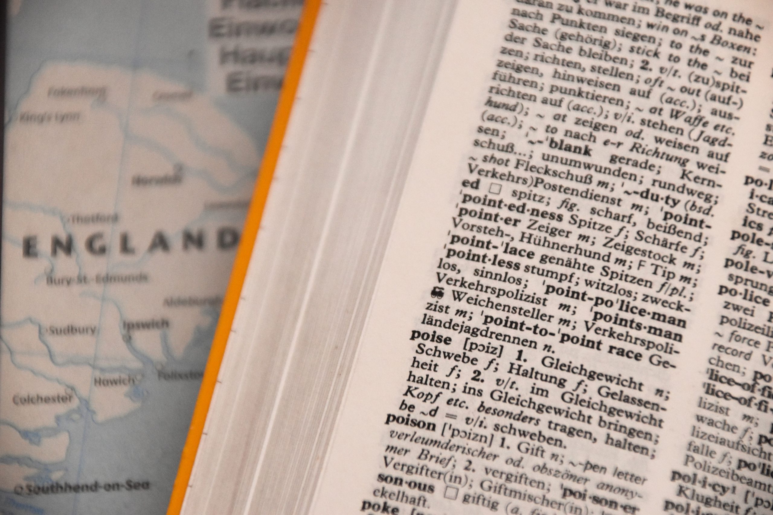 A portion of a map of England can be seen beneath a foreign language dictionary.
