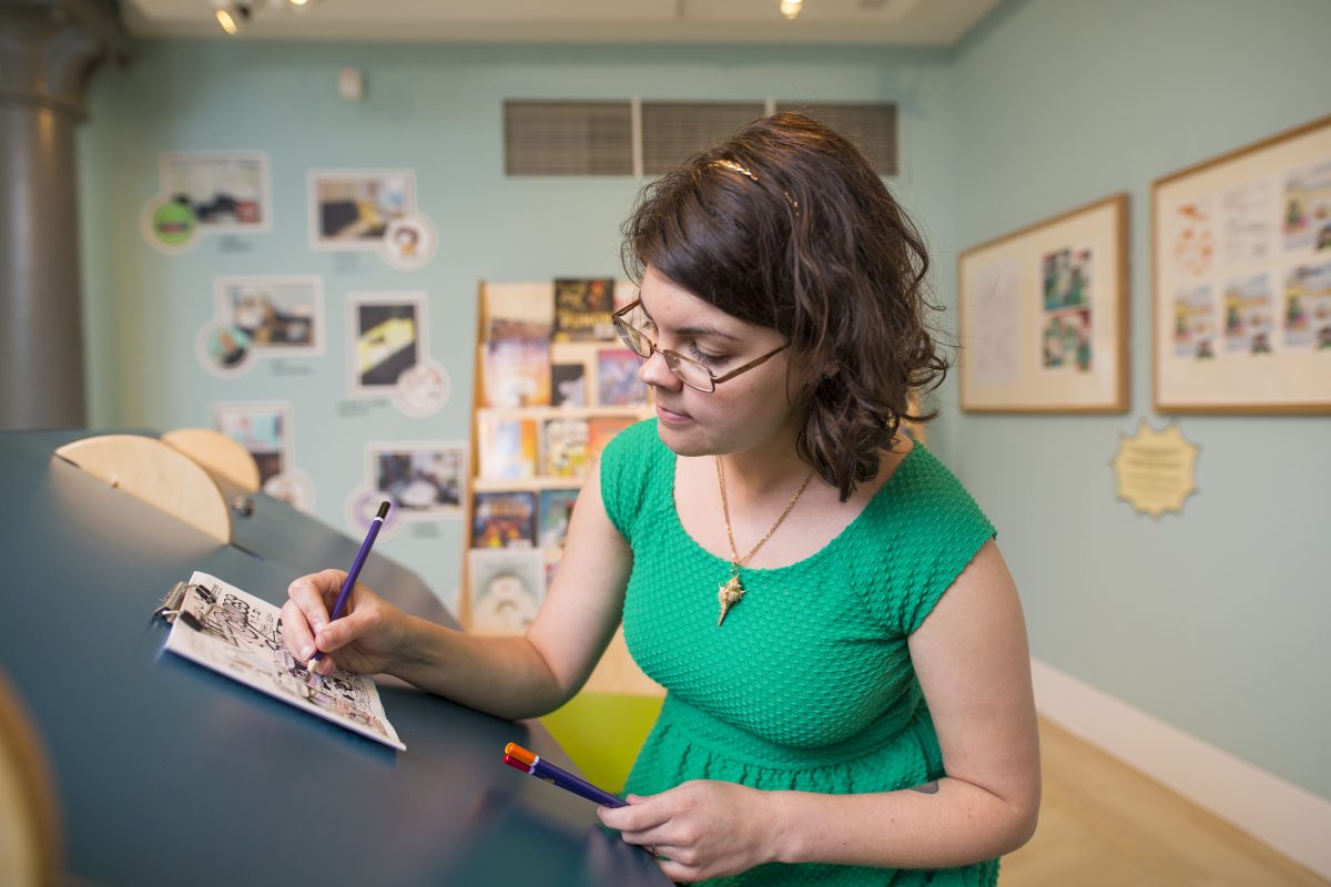Victoria creating a comic in Seven Stories' Comics exhibition. Image: Seven Stories, The National Centre for Children's Books, photography by Richard Kenworthy
